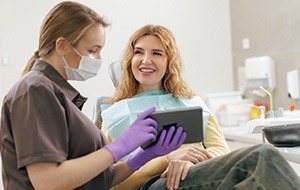 A smiling woman talking with her female dentist