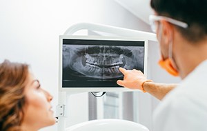 Dentist and patient looking at x-rays