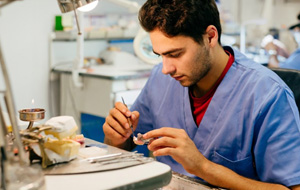 Dental lab technician crafting a dental crown