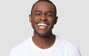 Man smiling brightly on white background
