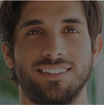 Man with brown hair and beard smiling