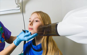 Preteen girl receiving dental x-rays