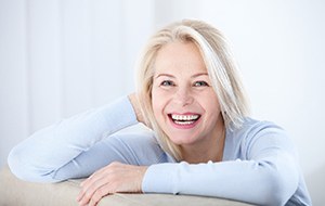 smiling woman sitting on a couch 