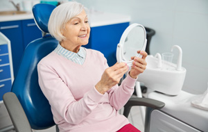 Senior woman smiling in the dental chair