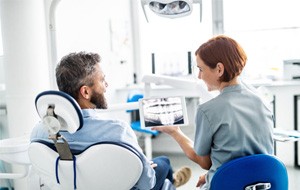 dentist explaining X-ray to patient 