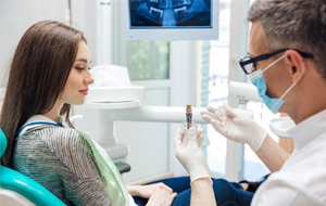 dentist explaining dental implant salvage 