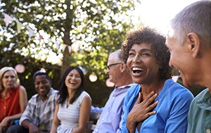 Diverse group of adult friends smiling together outside