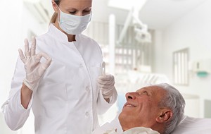 Smiling young woman in dental chair