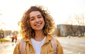 a student with a backpack on smiling