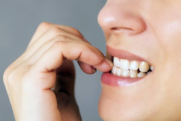 Woman biting her fingernails