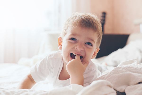 kid smiling in bedroom