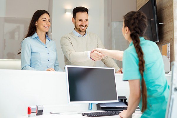 Couple speaking to dental staff