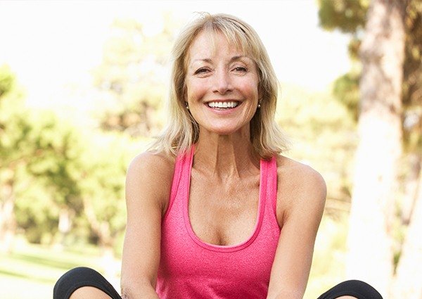 Smiling woman in exercise clothes