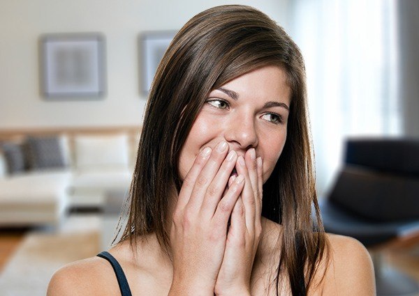 Woman covering her mouth