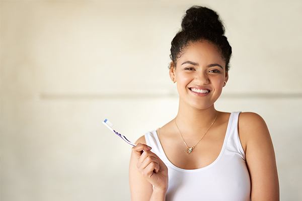 Woman holding a toothbrush