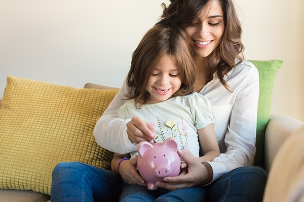 Mom and daughter with piggy bank