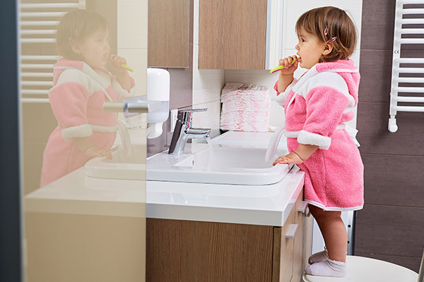 toddler brushing her teeth