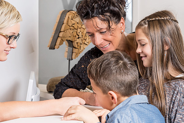 family signing up for a dental appointment