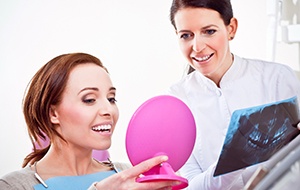 Woman looking at smile in mirror