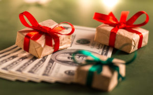 stack of money with small gifts