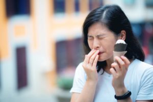 Woman with sensitive teeth and ice cream