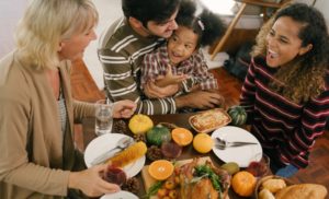 family of four enjoying some Thanksgiving foods 