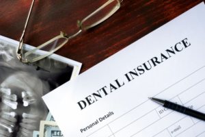 dental insurance form on dark wooden table 