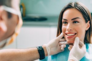 Dentist checking patient for oral cancer