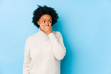 person with oral thrush covering their mouth 