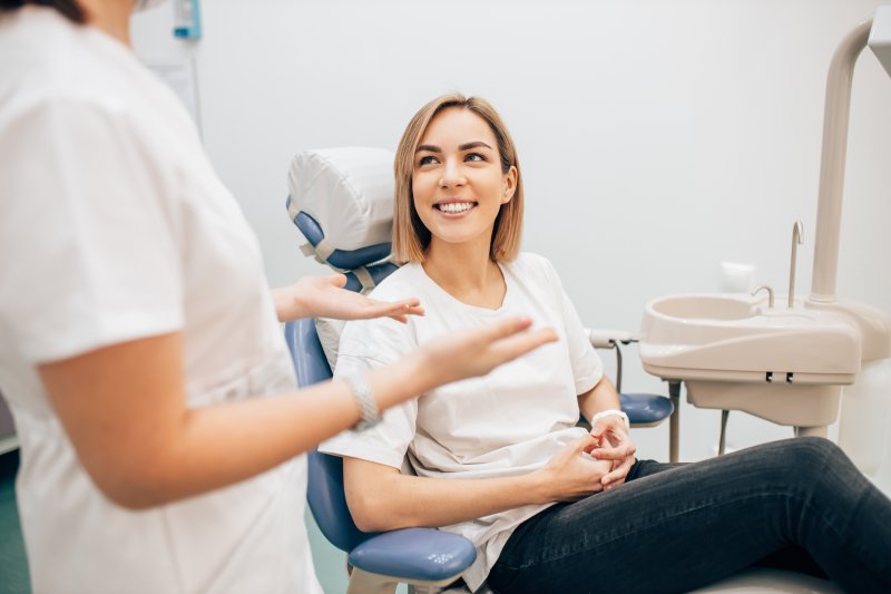Dentist talking to a woman during a routine check-up