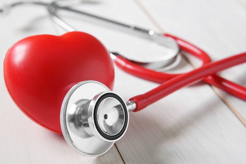 rubber heart next to a stethoscope