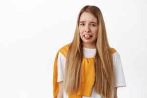 young woman making gross face