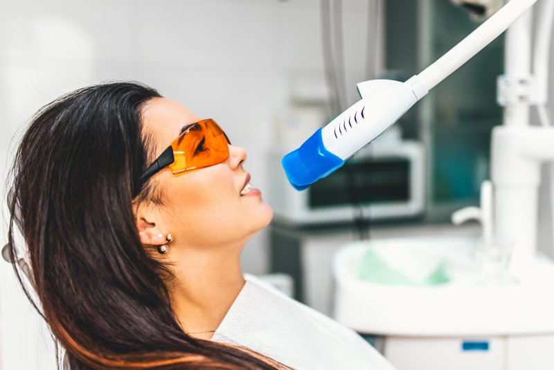 person at dentist having teeth whitened