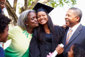 a girl with a beautiful smile celebrating graduation with her family