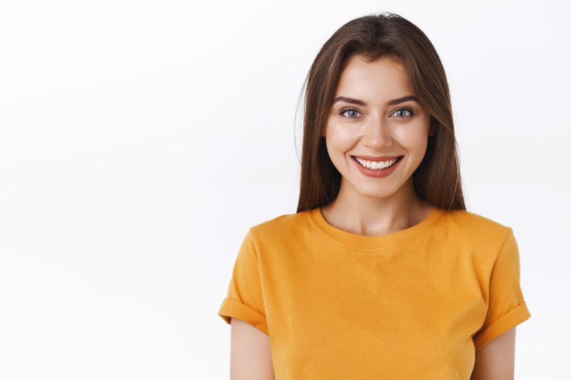 person with dental fillings smiling